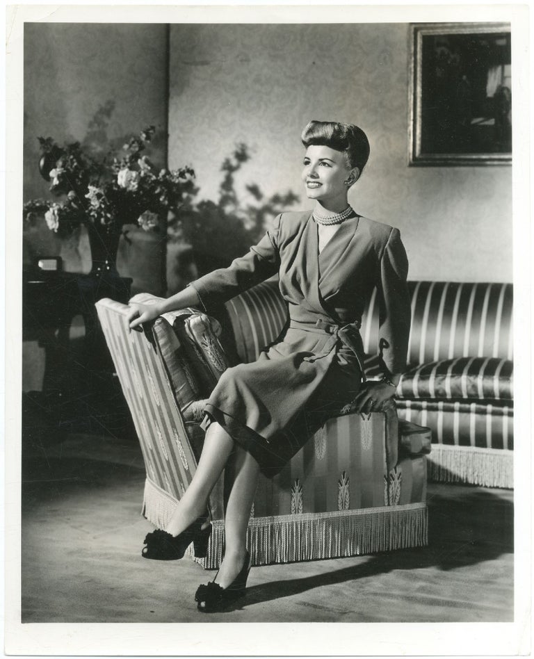 Item #426802 [Press photograph]: Janet Blair sitting on the arm of a chair. George HURRELL, Janet Blair.