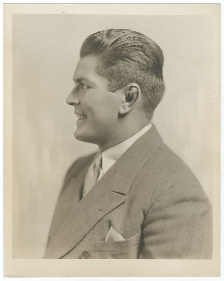 Photograph of Gene Tunney in a Suit smiling and looking to the left. Gene TUNNEY.