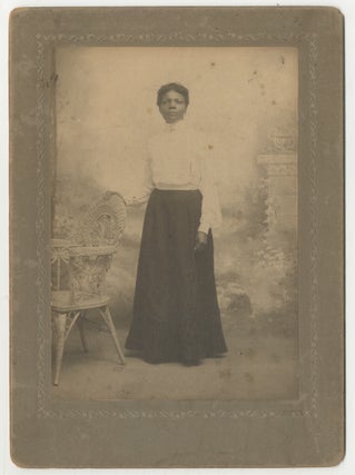 Item #443477 (Cabinet photograph): African-American Woman Standing with her hand on a wicker...
