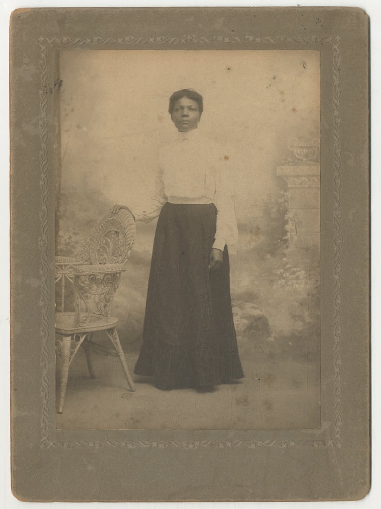 Item #443477 (Cabinet photograph): African-American Woman Standing with her hand on a wicker chair (circa 1890)