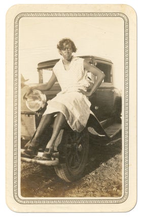 Item #544658 [Photograph]: An Unidentified African-American Woman Seated upon a Model A Ford