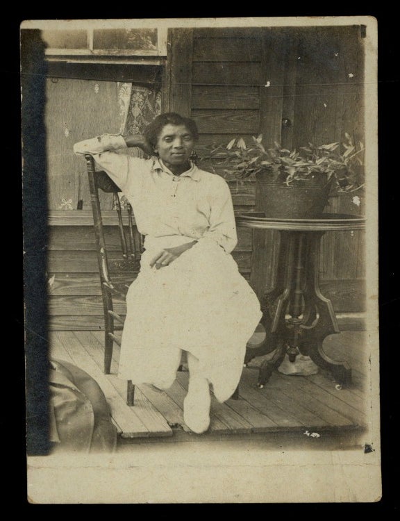 Item #622174 [RPPC]: African-American Woman Reclining on a Porch