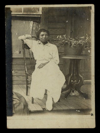 Item #622174 [RPPC]: African-American Woman Reclining on a Porch