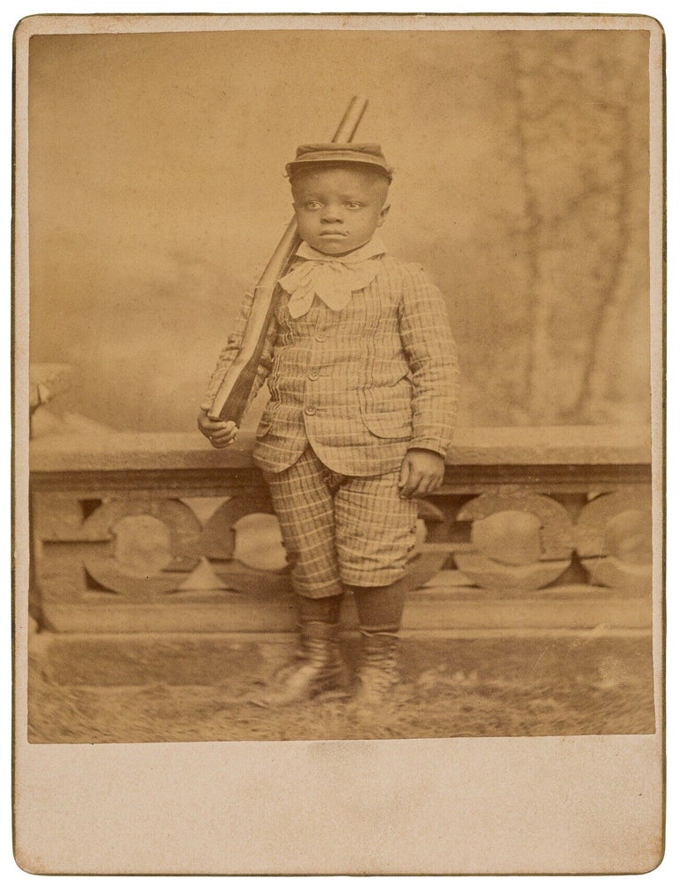 Item #624339 [Cabinet Card Photograph]: A Well-Dressed Young African-American Boy Standing at Attention with a Toy Rifle and Wearing a Military Kepi Cap