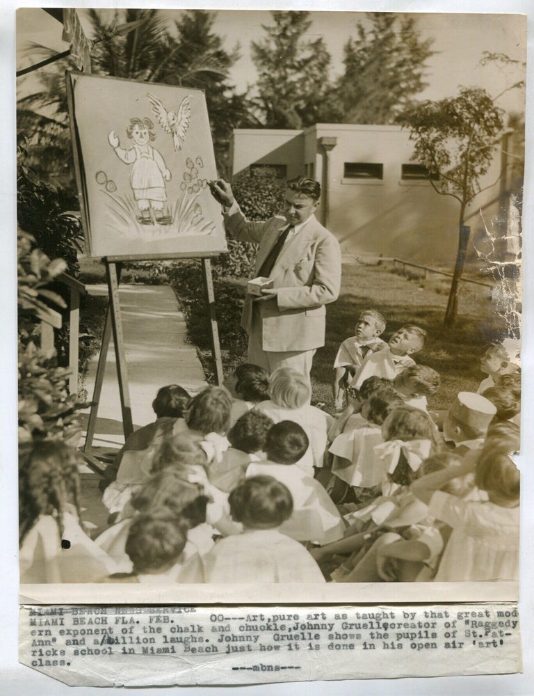 Item #625742 [Wire service photograph]: Johnny Gruelle draws Raggedy Andy for Miami, Florida School Children. Johnny GRUELLE.